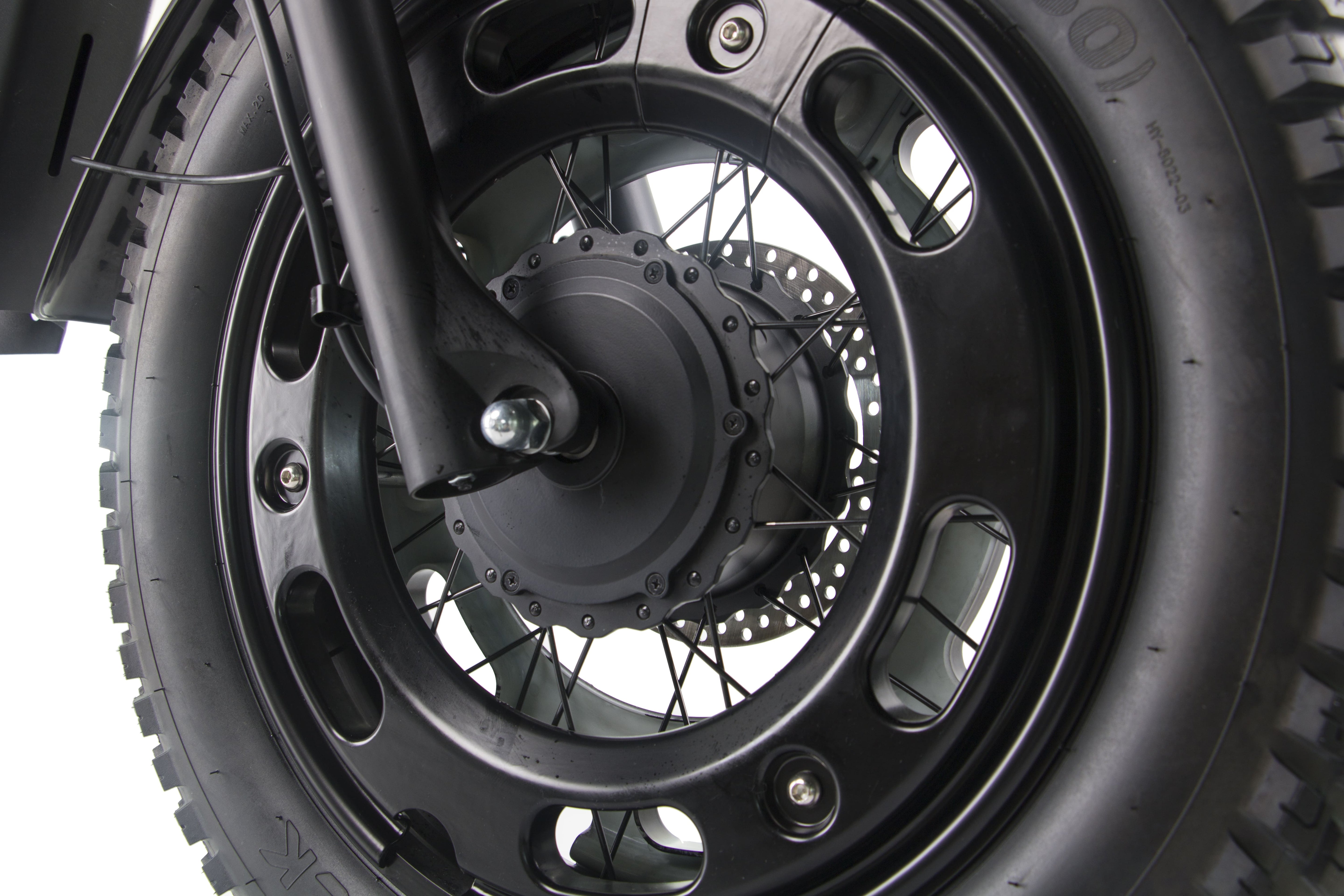 Black front wheel hub and brake rotor on a black electric motorcycle.