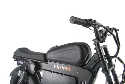 Black electric motorcycle front three-quarter view showing seat and headlight.