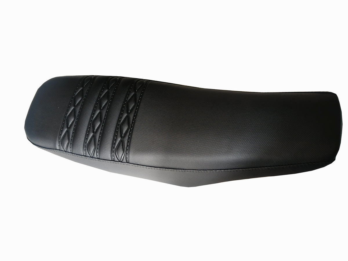 Black dirt bike seat with stitched ribbed pattern on top
