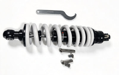 QF200 shock absorber shown horizontally with white spring, wrench and mounting hardware