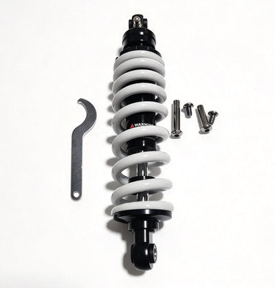 QF200 shock absorber with white coil spring and black body, viewed upright beside wrench and bolts