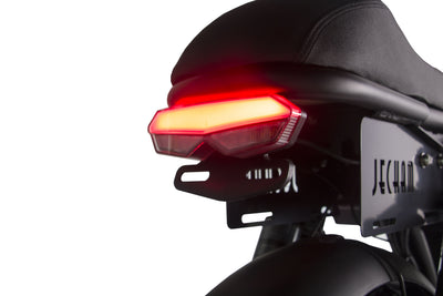 Rear light bar illuminated on a black electric motorcycle near the license plate.