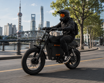 Black small motorcycle with rider, front 3/4 view, headlight on